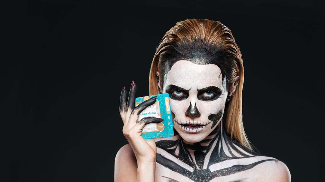 girl with skeleton halloween makeup holding foreo ufo mask matte maniac