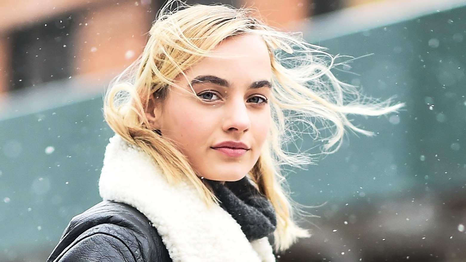Girl with short blonde hair in snow outside