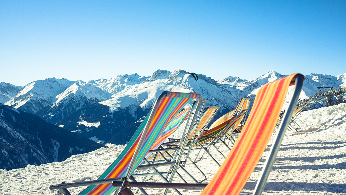 Colorful lounge chairs in the snowy mountain landscape