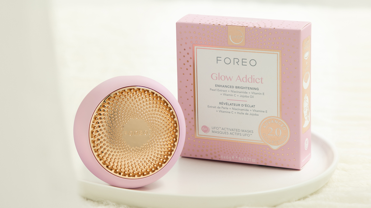 FOREO UFO 3 in pearl color together with FOREO Glow Addict mask in a neutral bathroom