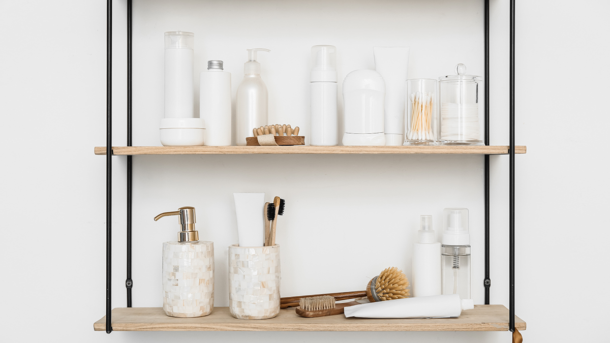 Neatly organized bathroom shelves with neutral bottles and brushes